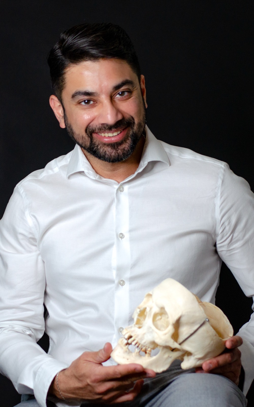 Dr. Anurag Bhargava, editorial portrait with anatomical skull model