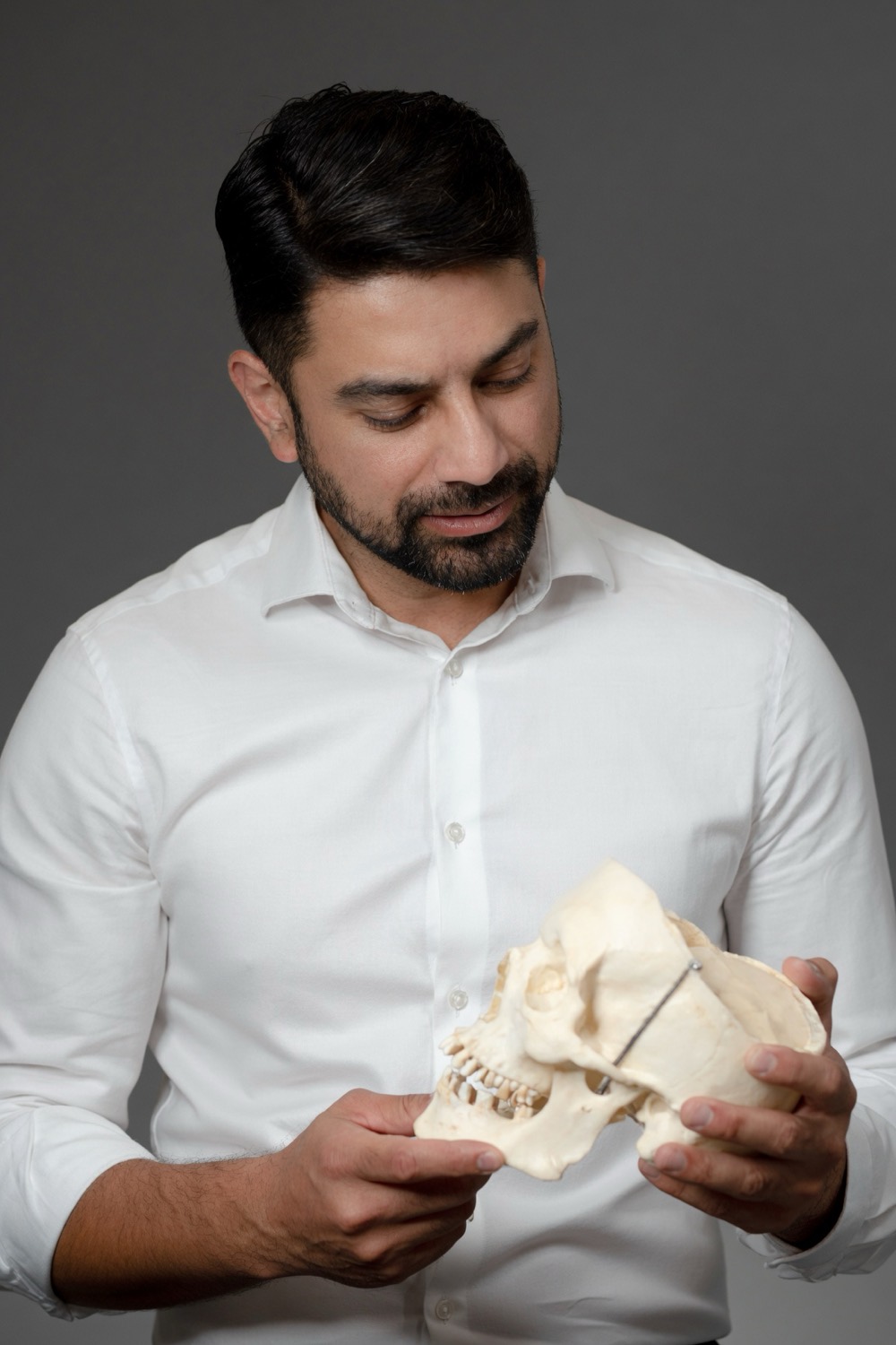 Dr. Bhargava reviewing an anatomical model in the studio